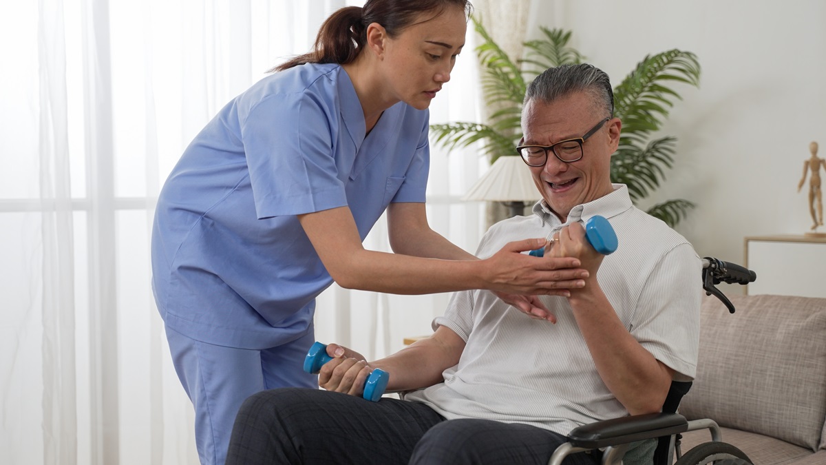 Asian,Paralyzed,Elderly,Man,Sitting,In,Wheelchair,And,Going,Through